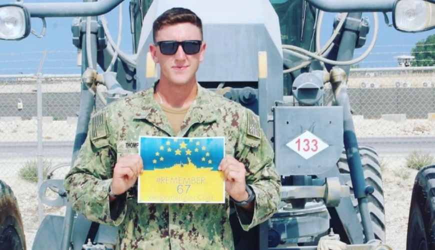 Hunter Thompson holds up a certificate while on deployment in Bahrain.