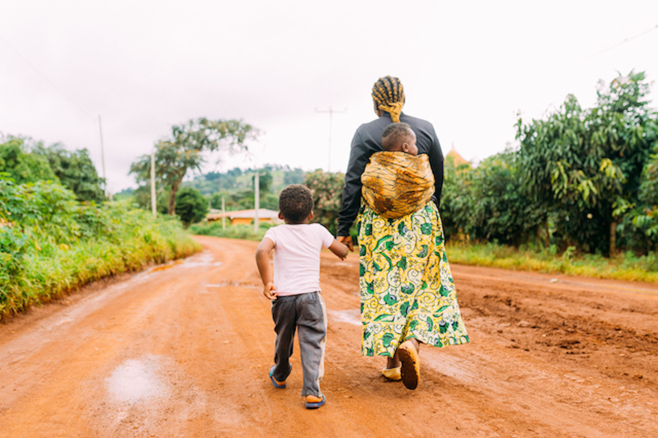 Woman walks with children