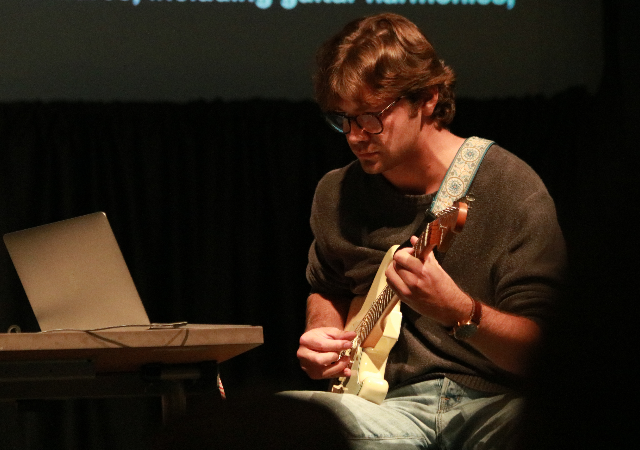 A student in the Digital Audio course performing on stage …