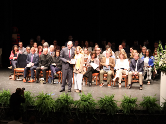 president harris and student recipient on stage at the …