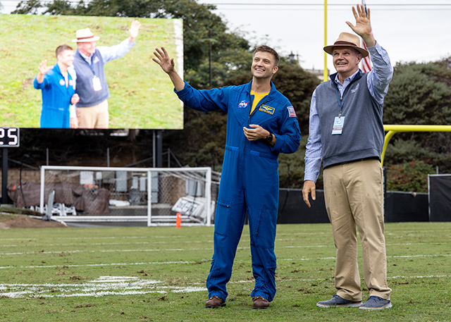 NASA astronaut Matthew Dominick '05 (BS/BA) and USD President James T. Harris III, DEd.&nbsp;, wave to Torero fans during halftime of the homecoming football game against Presbyterian. (Photo by Alé Delgado)