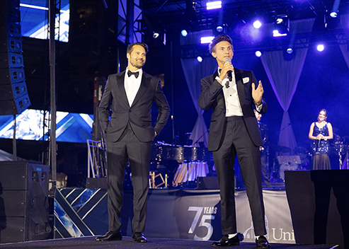 USD alumni Joe Kudla ’00, left, and Michael Persall ’02 on stage at the 75th Anniversary Founders Gala on Saturday, Nov. 16, 2024. (Photo by Zachary Barron)