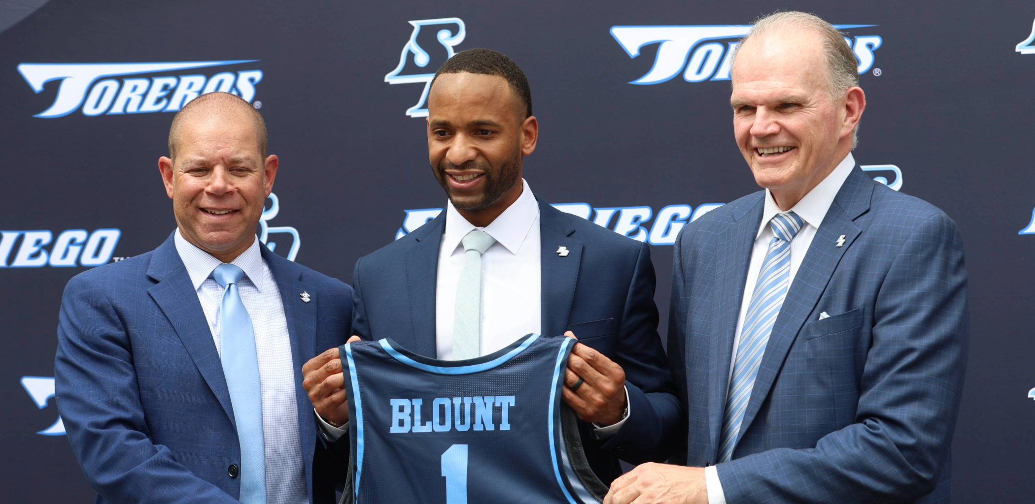 Left to right: USD Associate Vice President and Executive Director of Athletics Kimya Massey, Men's Basketball Head Coach JR Blount, President James T. Harris III, DED
