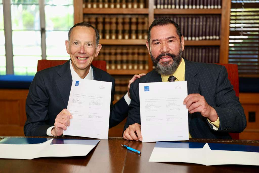 Deans holding signed MOU