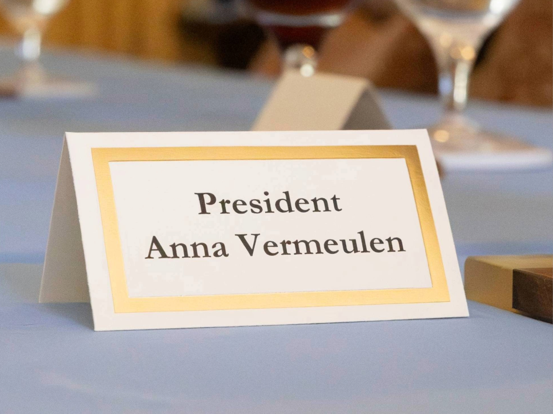 The name tag stating "president anna vermeulen" 