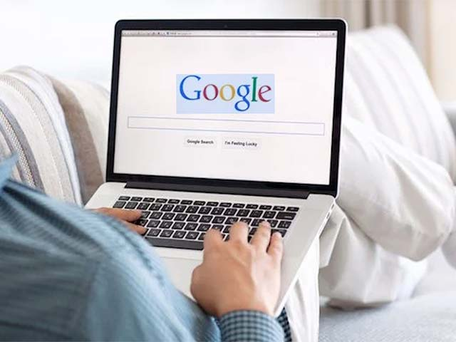 someone searching google with their laptop