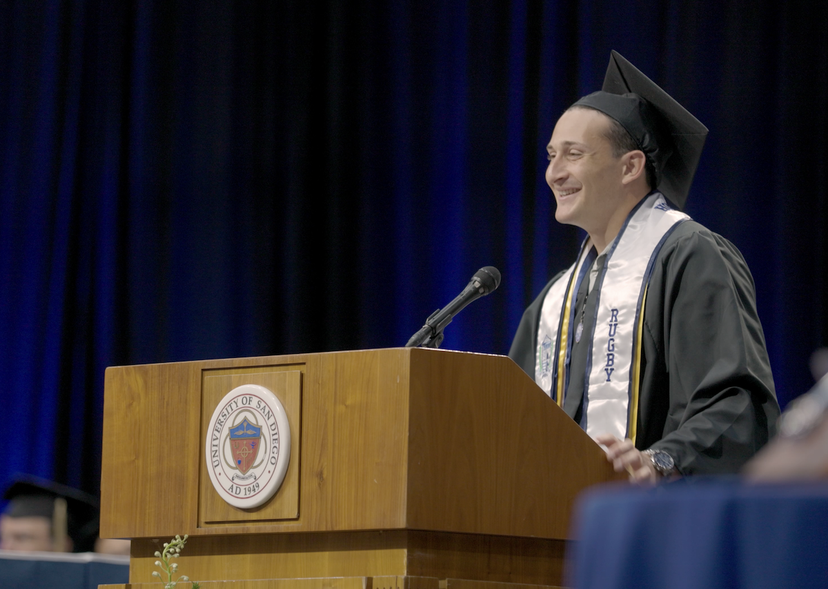 JD Mouri presenting at commencement. 