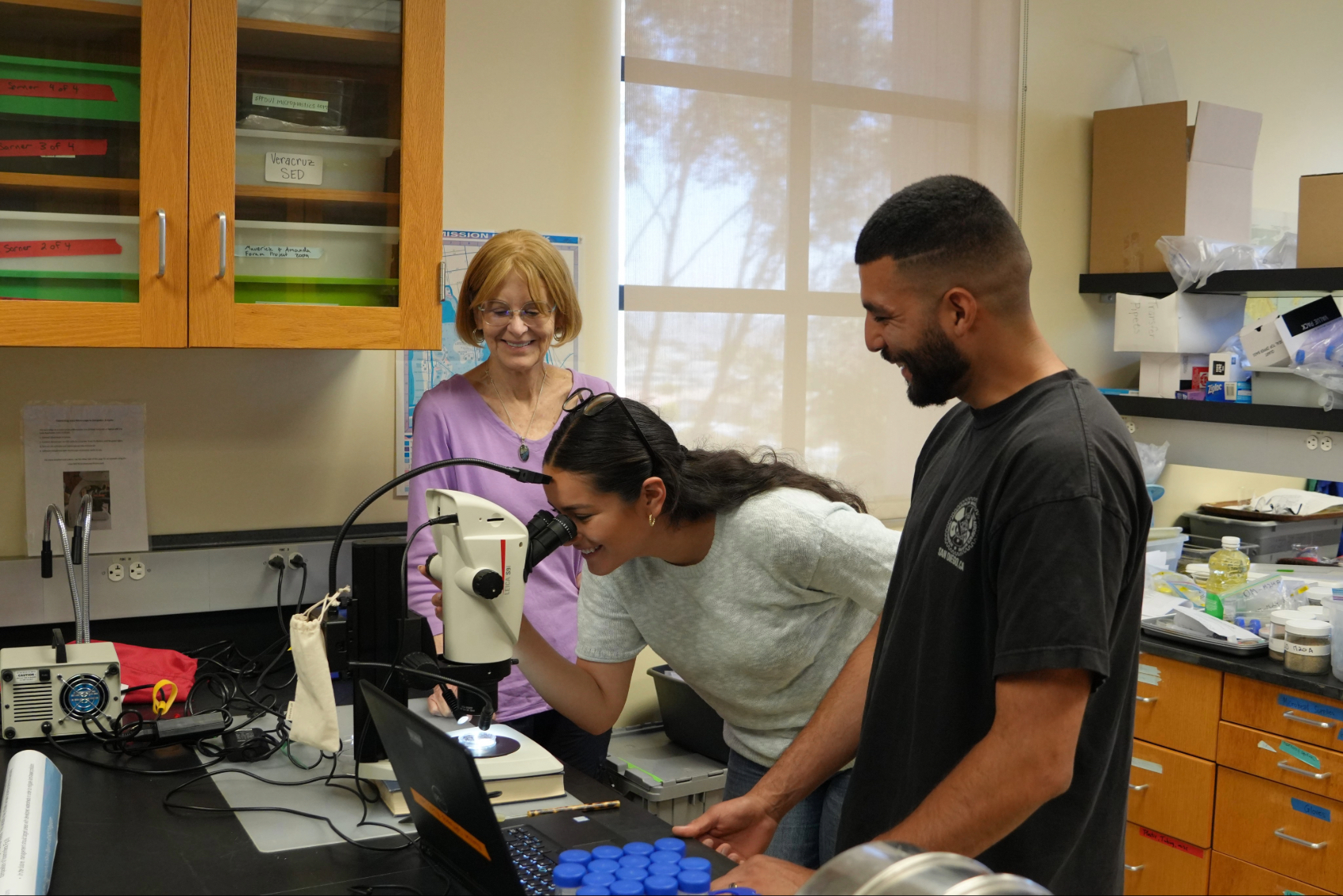 Valeria Negrete, David Salinas, and Sarah Gray researching in the lab.