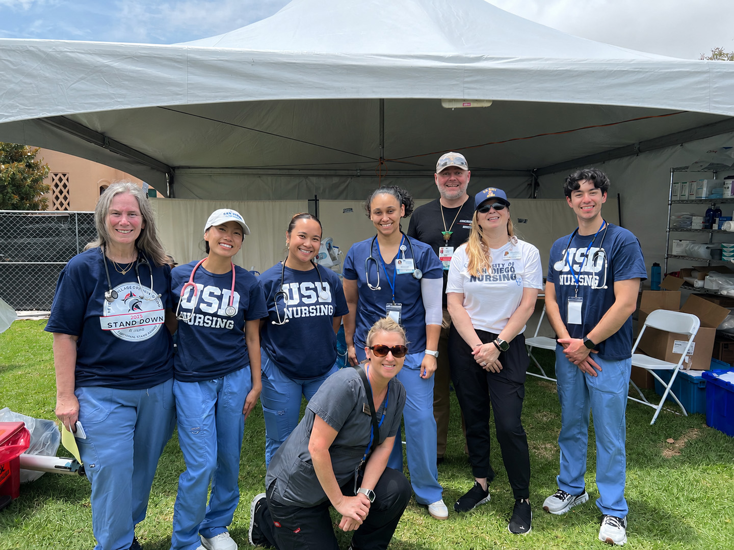 HSON Master's Entry Program in Nursing (MEPN) students, faculty, and volunteers pose together at Operation Stand Down, where they provided compassionate care and support for veterans experiencing homelessness.