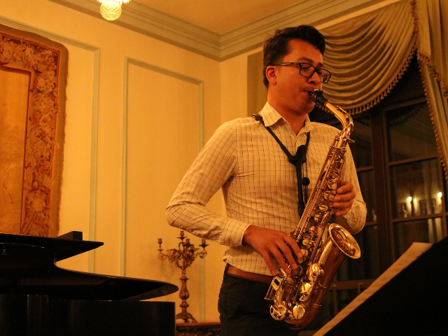 USD faculty member performing saxophone in the French Parlor