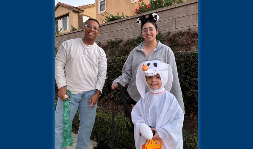 USD student veteran Jack Atkinson poses with his wife and son for a photo during Halloween.