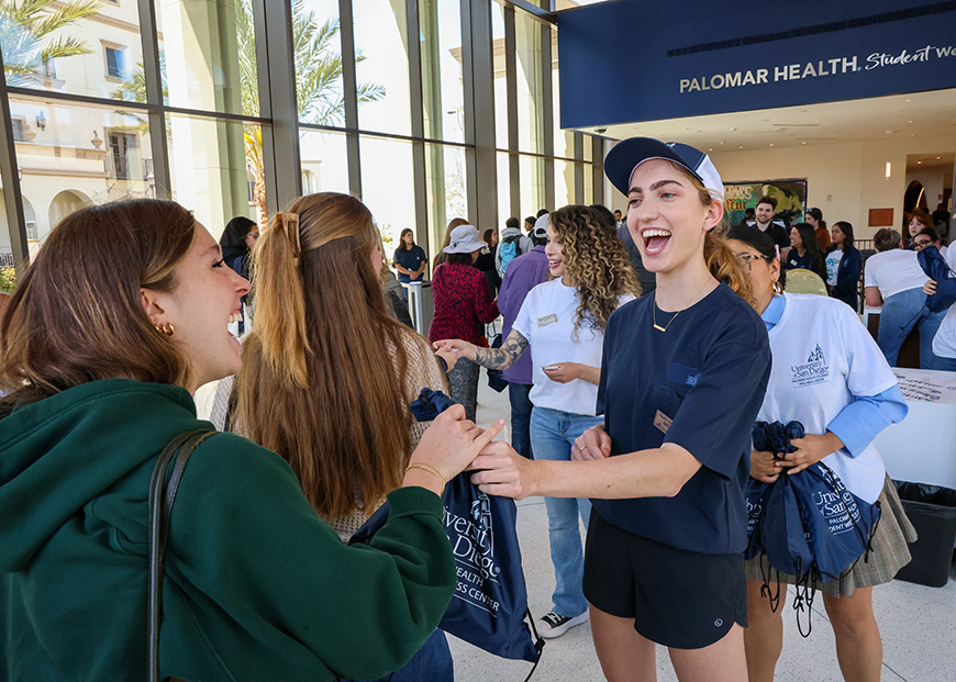 USD Students receive napsacks in the lobby of the new Palomar Health Student Wellness Center on Tuesday, April 22, 2025. The university held its ribbon cutting and dedication ceremony for the center, and welcomed the community into the new space for the first time. (Photo by Matthew Piechalak)