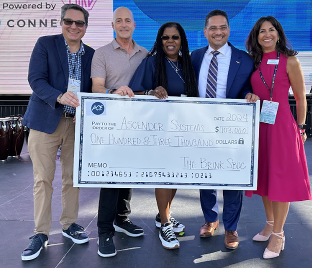 Check presentation, from left to right: Daniel Fitzgerald, Executive Director, San Diego & Imperial SBDC; Wolf Bielas, Managing Partner of Downtown Works; Tara Lynn Gray, Director of CalOSBA; Jorge Muniz, Jr, co-founder of Ascender Systems, and Amy Duncan, Director of The Brink SBDC.