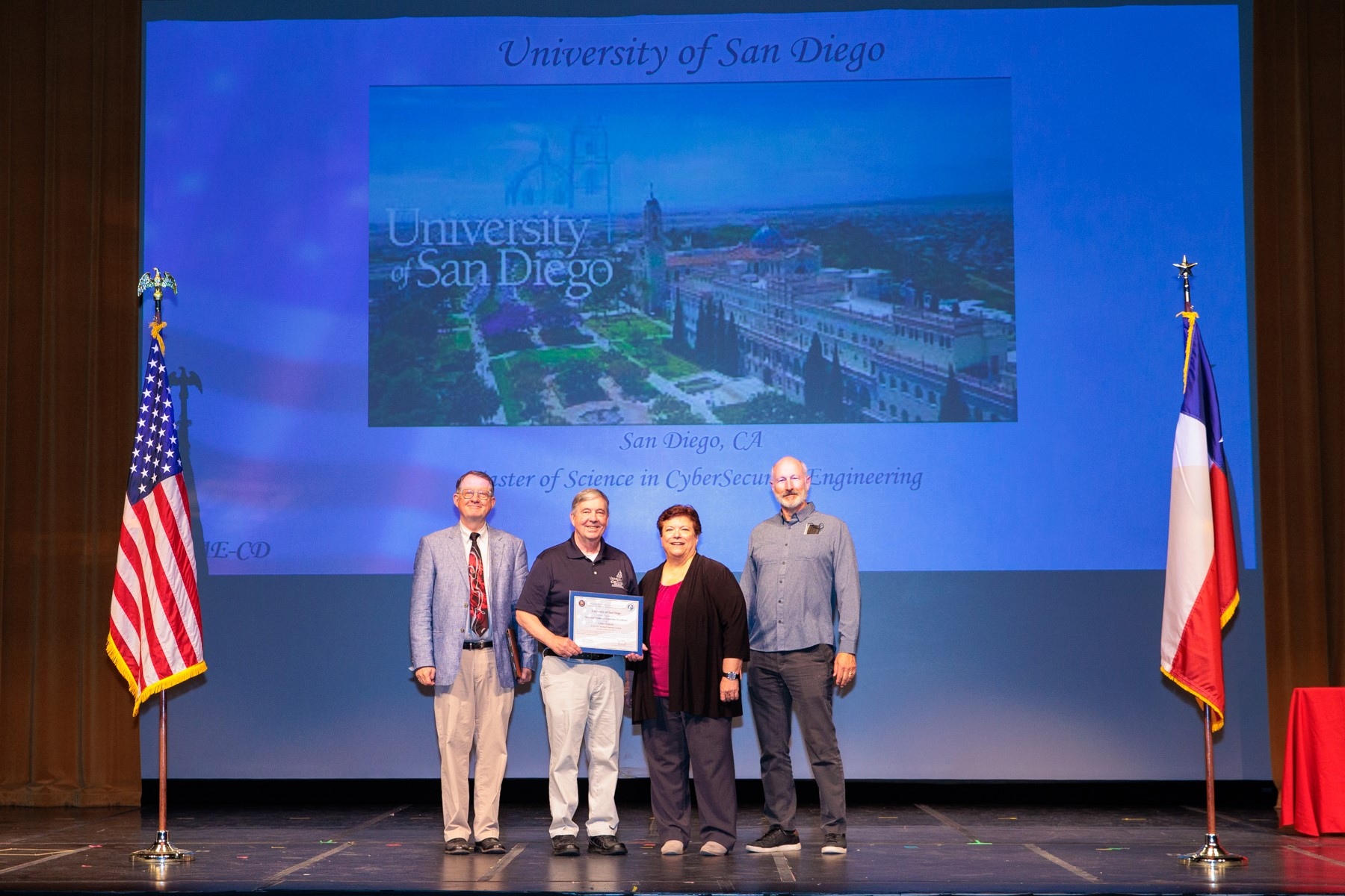Dean Roberts (left), Chuck Bane (left center) and Mark Heckman (right) accept award for National Center for Academic Excellence Designation.
