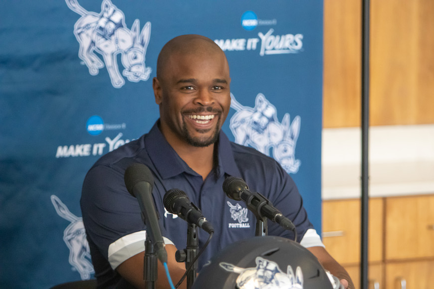 image of Coach Moore at podium answering questions