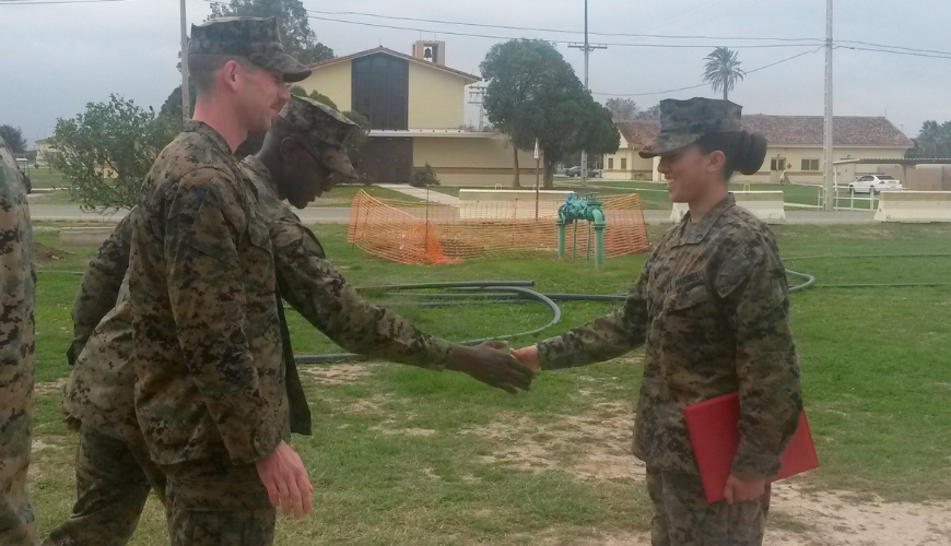 Lissette Nichols shakes hand of a fellow Marine.