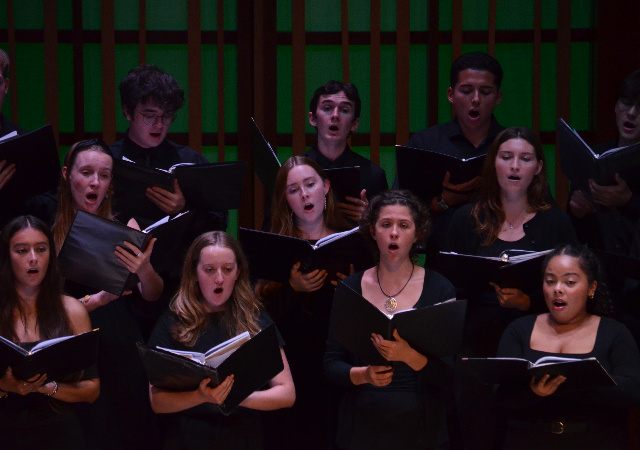 Students in the Concert Choir singing on stage.